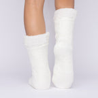The Foozie™ in White, back view with one foot raised to show the sole