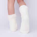 The Foozie™ in White, back view worn in Kids/Small with one foot raised to show the sole